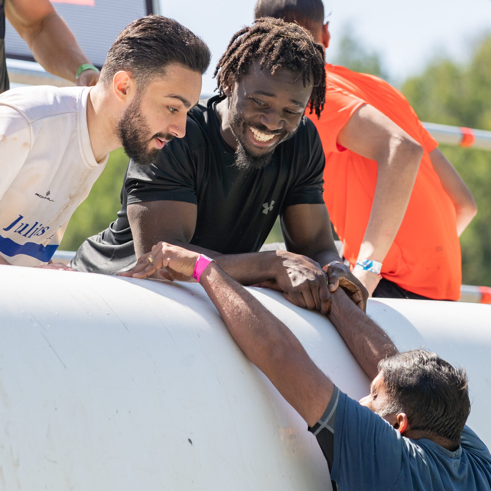 Participant grabbing on his teammates to climb the top of Everest