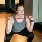 Woman squatting with resistance band